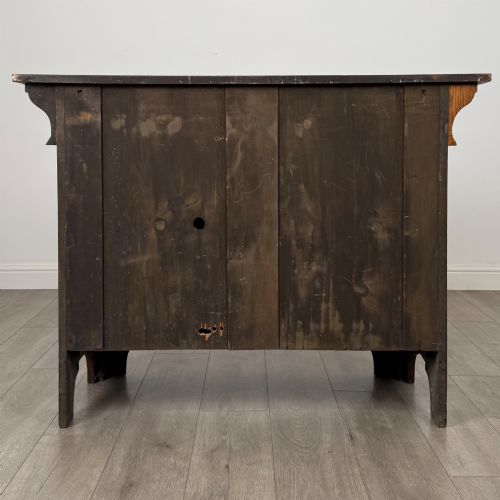 fig 5. An Arts and Crafts golden oak sideboard featuring two top drawers, two lower cupboard doors, and stylized copper strap hinges.