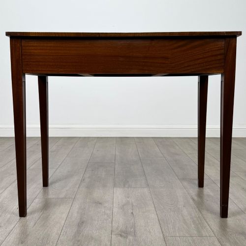 fig 4. A 20th-century burr walnut side table featuring a serpentine front, three drawer fronts with brass handles, and square tapered legs.