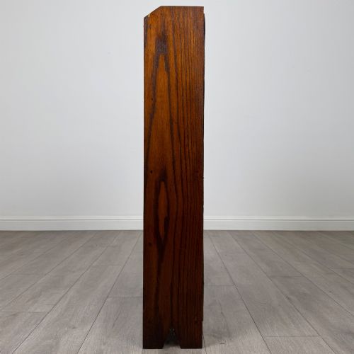 fig 3. An Edwardian dark oak open bookcase featuring four fixed shelves and shaped side panels.