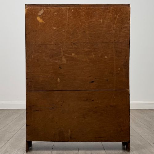 fig 5. An Edwardian dark oak open bookcase featuring four fixed shelves and shaped side panels.