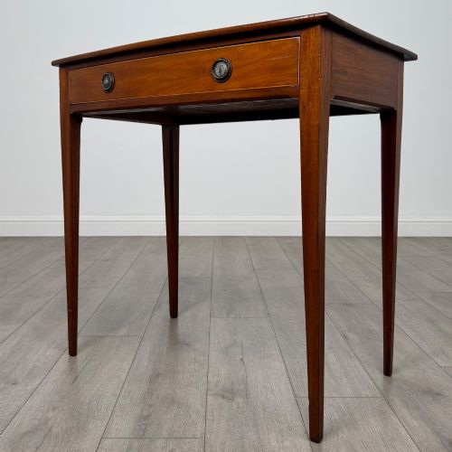 fig 1. An 18th-century Georgian mahogany writing table featuring a single full-width drawer with two circular brass handles and tapered square legs.