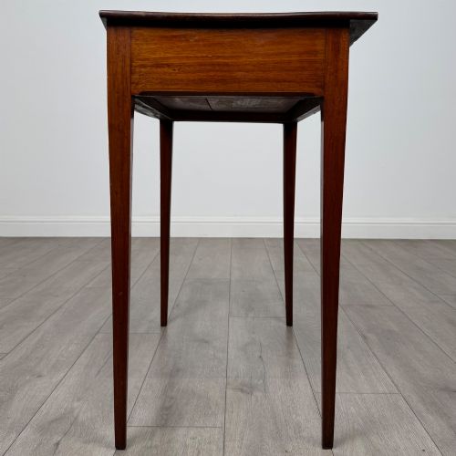 fig 2. An 18th-century Georgian mahogany writing table featuring a single full-width drawer with two circular brass handles and tapered square legs.
