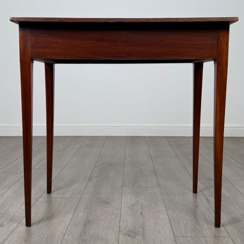 fig 4. An 18th-century Georgian mahogany writing table featuring a single full-width drawer with two circular brass handles and tapered square legs.