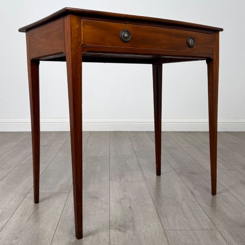 fig 7. An 18th-century Georgian mahogany writing table featuring a single full-width drawer with two circular brass handles and tapered square legs.