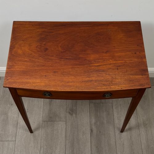 fig 8. An 18th-century Georgian mahogany writing table featuring a single full-width drawer with two circular brass handles and tapered square legs.