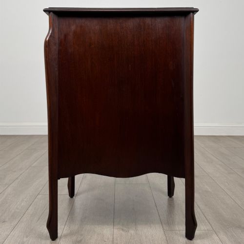 fig 3. An antique Edwardian mahogany cabinet with double panelled doors, brass knobs, and elevated curved legs.