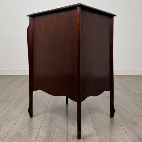 fig 4. An antique Edwardian mahogany cabinet with double panelled doors, brass knobs, and elevated curved legs.