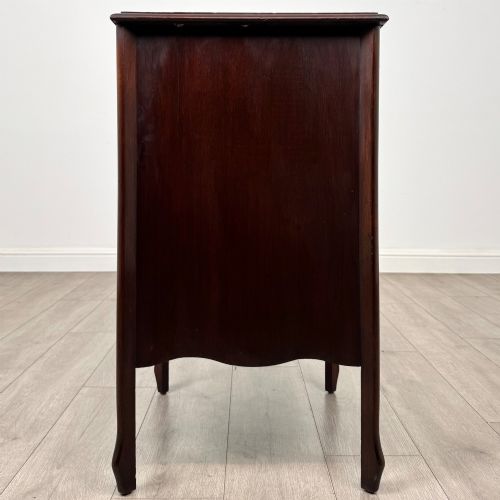 fig 5. An antique Edwardian mahogany cabinet with double panelled doors, brass knobs, and elevated curved legs.