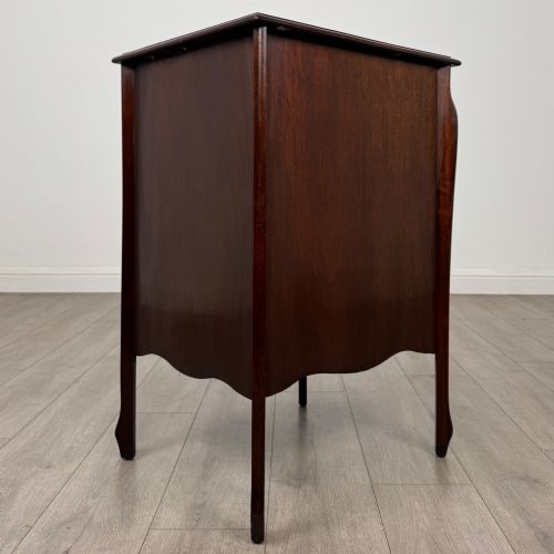 fig 6. An antique Edwardian mahogany cabinet with double panelled doors, brass knobs, and elevated curved legs.