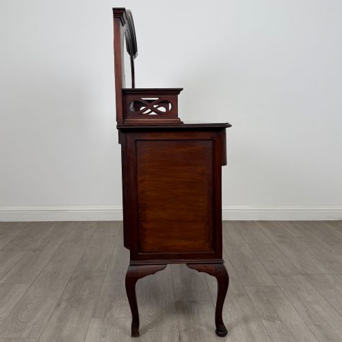 fig 7. An antique Edwardian mahogany sideboard featuring a top section with a central oval mirror, two drawers, and a two-door cabinet below raised on cabriole legs.