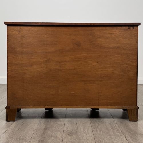 fig 5. An antique 20th-century small breakfront sideboard with figured burr walnut veneers, brass drop handles, four central drawers, and side cupboard doors.