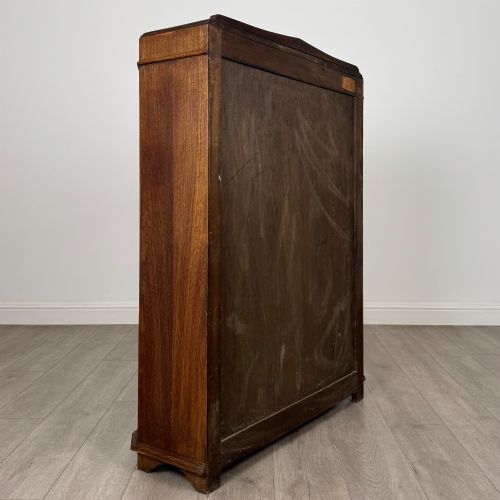 fig 4. A twin-door dark oak display cabinet featuring leaded glass upper panels, carved decorative lower panels, and ornate metal hinges.
