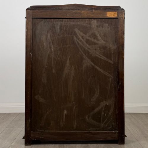 fig 5. A twin-door dark oak display cabinet featuring leaded glass upper panels, carved decorative lower panels, and ornate metal hinges.
