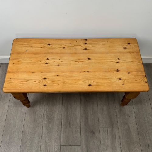 fig 8. A low rectangular pine coffee table featuring turned baluster legs and visible wooden grain across its solid tabletop.