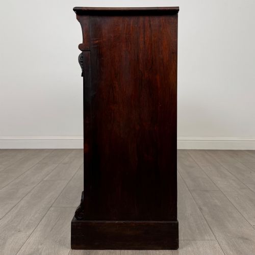 fig 2. A low 19th-century Victorian rosewood open bookcase with two wide shelves, carved acanthus leaf capitals, and a solid plinth base.