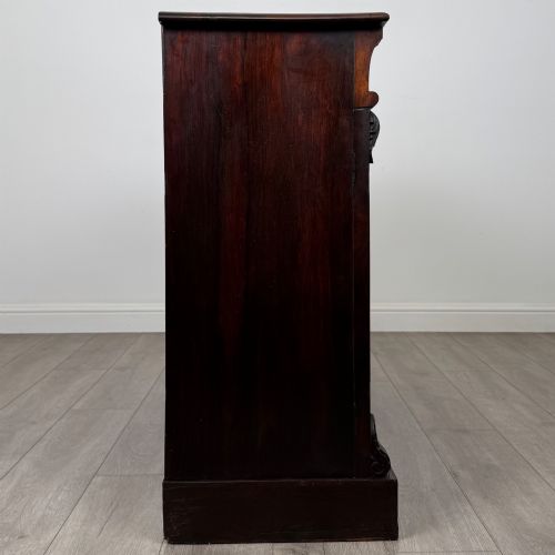 fig 6. A low 19th-century Victorian rosewood open bookcase with two wide shelves, carved acanthus leaf capitals, and a solid plinth base.