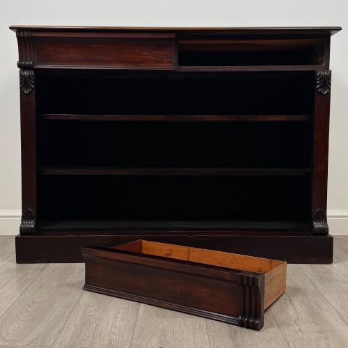 fig 9. A low 19th-century Victorian rosewood open bookcase with two wide shelves, carved acanthus leaf capitals, and a solid plinth base.