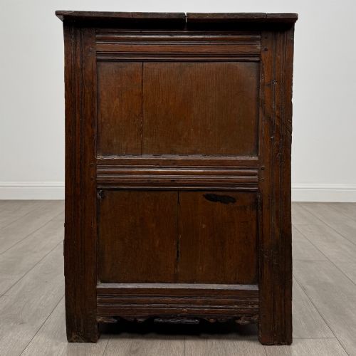 fig 3. A seventeenth-century oak cupboard featuring two panelled doors with moulded trim and hand-forged iron hinges.