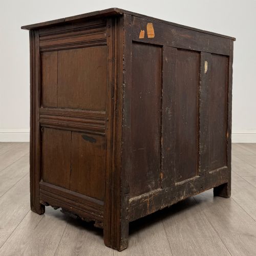 fig 4. A seventeenth-century oak cupboard featuring two panelled doors with moulded trim and hand-forged iron hinges.