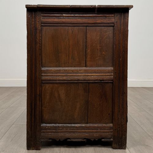 fig 7. A seventeenth-century oak cupboard featuring two panelled doors with moulded trim and hand-forged iron hinges.