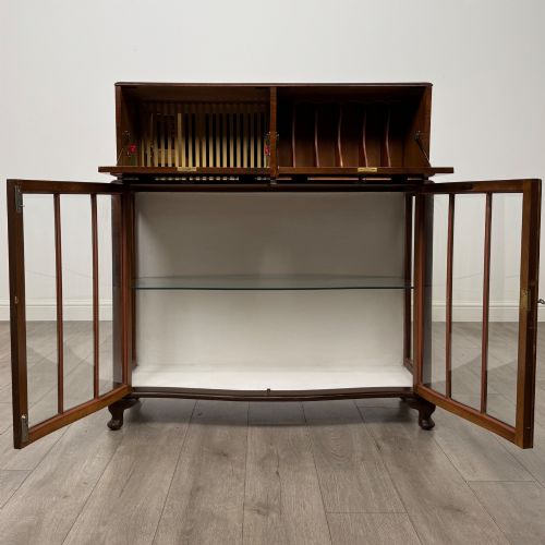 fig 2. A 20th-century figured walnut fitted cabinet featuring upper solid doors above lower glazed doors with glass shelving.