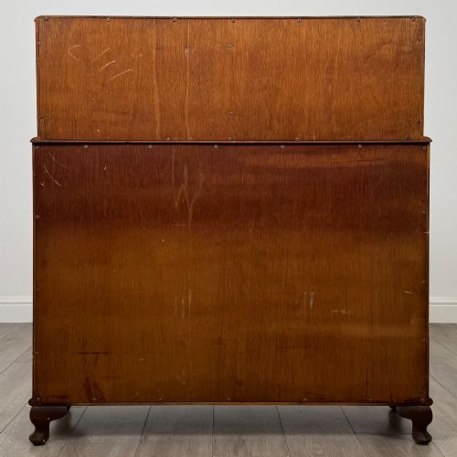 fig 5. A 20th-century figured walnut fitted cabinet featuring upper solid doors above lower glazed doors with glass shelving.