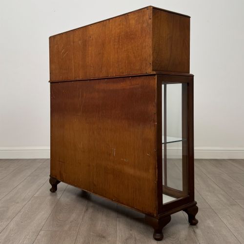 fig 6. A 20th-century figured walnut fitted cabinet featuring upper solid doors above lower glazed doors with glass shelving.