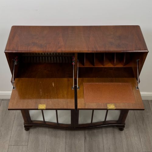 fig 9. A 20th-century figured walnut fitted cabinet featuring upper solid doors above lower glazed doors with glass shelving.