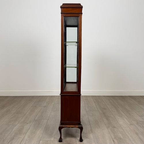fig 3. An early 20th-century mahogany glazed display cabinet featuring geometric astragal doors, marquetry inlaid lower cupboards, and cabriole legs.