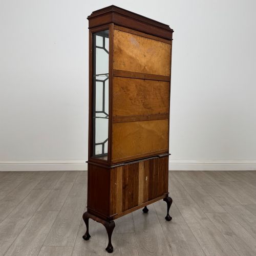 fig 4. An early 20th-century mahogany glazed display cabinet featuring geometric astragal doors, marquetry inlaid lower cupboards, and cabriole legs.