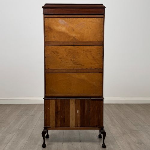 fig 5. An early 20th-century mahogany glazed display cabinet featuring geometric astragal doors, marquetry inlaid lower cupboards, and cabriole legs.