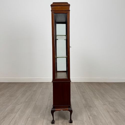 fig 7. An early 20th-century mahogany glazed display cabinet featuring geometric astragal doors, marquetry inlaid lower cupboards, and cabriole legs.