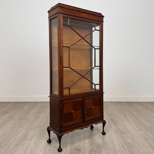 fig 8. An early 20th-century mahogany glazed display cabinet featuring geometric astragal doors, marquetry inlaid lower cupboards, and cabriole legs.