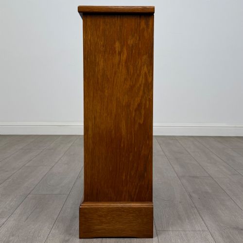 fig 2. A small 20th-century open oak bookcase featuring two drawers at the top with dark twisted ring handles above two open shelves.