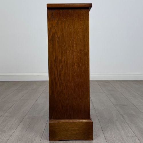 fig 6. A small 20th-century open oak bookcase featuring two drawers at the top with dark twisted ring handles above two open shelves.