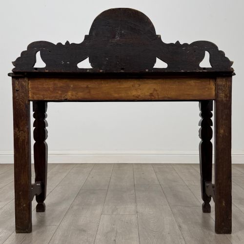 fig 4. A dark carved oak Victorian side table featuring a sculpted mask upstand gallery, relief-carved frieze, and detailed carved legs.
