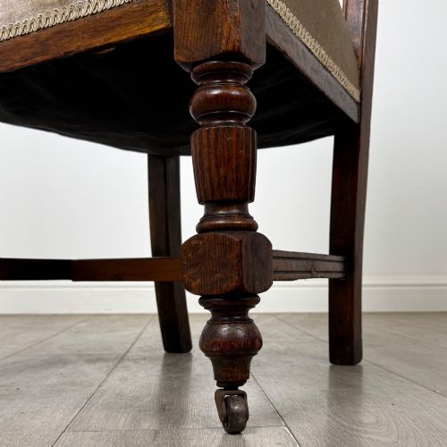 fig 5. A set of four 19th-century Victorian carved oak dining chairs featuring beige upholstered seats, turned legs, and detailed crest carved backrests.