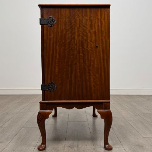 fig 3. A 20th-century burr walnut two-door fitted cabinet on cabriole legs with carved shell knees and decorative pierced brass hinges.