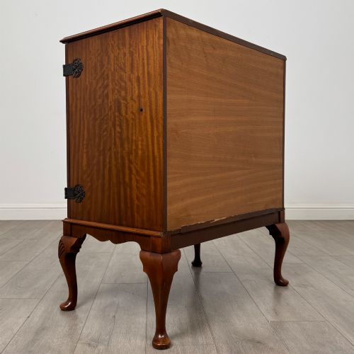 fig 4. A 20th-century burr walnut two-door fitted cabinet on cabriole legs with carved shell knees and decorative pierced brass hinges.