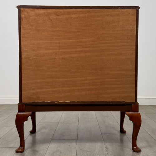 fig 5. A 20th-century burr walnut two-door fitted cabinet on cabriole legs with carved shell knees and decorative pierced brass hinges.