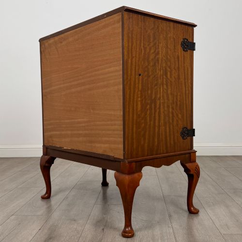 fig 6. A 20th-century burr walnut two-door fitted cabinet on cabriole legs with carved shell knees and decorative pierced brass hinges.
