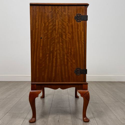 fig 7. A 20th-century burr walnut two-door fitted cabinet on cabriole legs with carved shell knees and decorative pierced brass hinges.