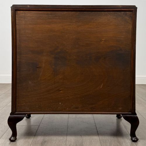 fig 4. A mahogany chest of drawers featuring four full-width drawers with flame veneer fronts, brass handles, and cabriole legs.