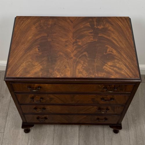 fig 8. A mahogany chest of drawers featuring four full-width drawers with flame veneer fronts, brass handles, and cabriole legs.