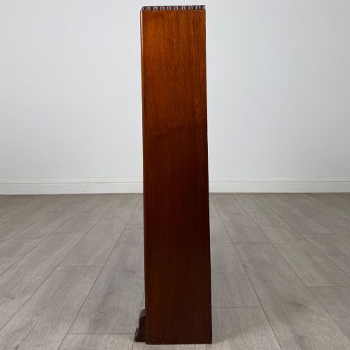 fig 3. An antique narrow mahogany open bookcase featuring three tiers, a gadrooned top edge, and carved bracket feet.