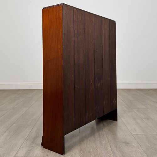 fig 4. An antique narrow mahogany open bookcase featuring three tiers, a gadrooned top edge, and carved bracket feet.