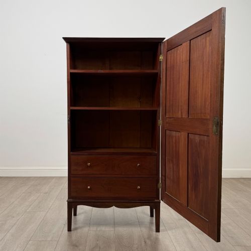fig 1. An 18th-century Georgian dark mahogany standing cabinet featuring two tall recessed field-panel doors, a subtle curved apron, and square tapered legs.