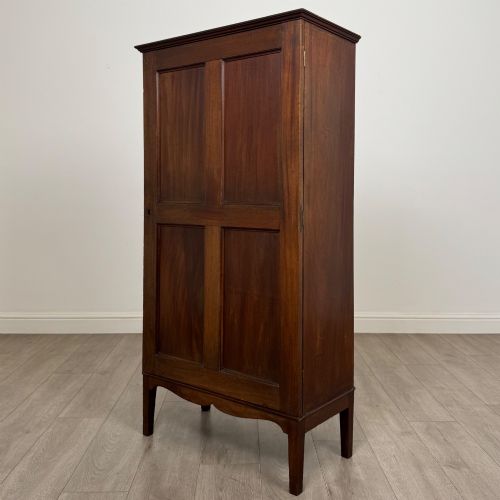 fig 2. An 18th-century Georgian dark mahogany standing cabinet featuring two tall recessed field-panel doors, a subtle curved apron, and square tapered legs.
