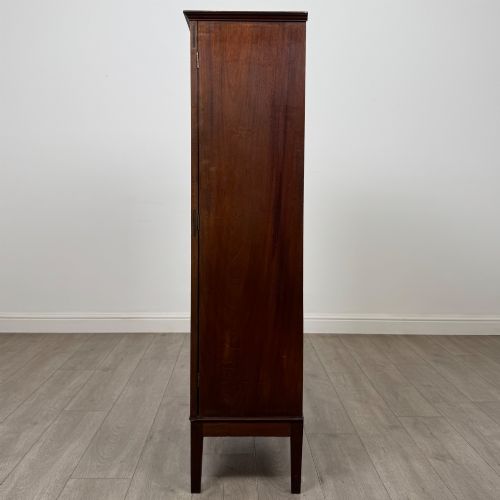fig 3. An 18th-century Georgian dark mahogany standing cabinet featuring two tall recessed field-panel doors, a subtle curved apron, and square tapered legs.