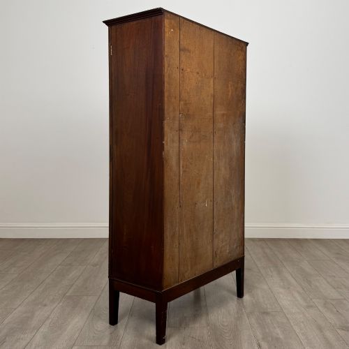 fig 4. An 18th-century Georgian dark mahogany standing cabinet featuring two tall recessed field-panel doors, a subtle curved apron, and square tapered legs.